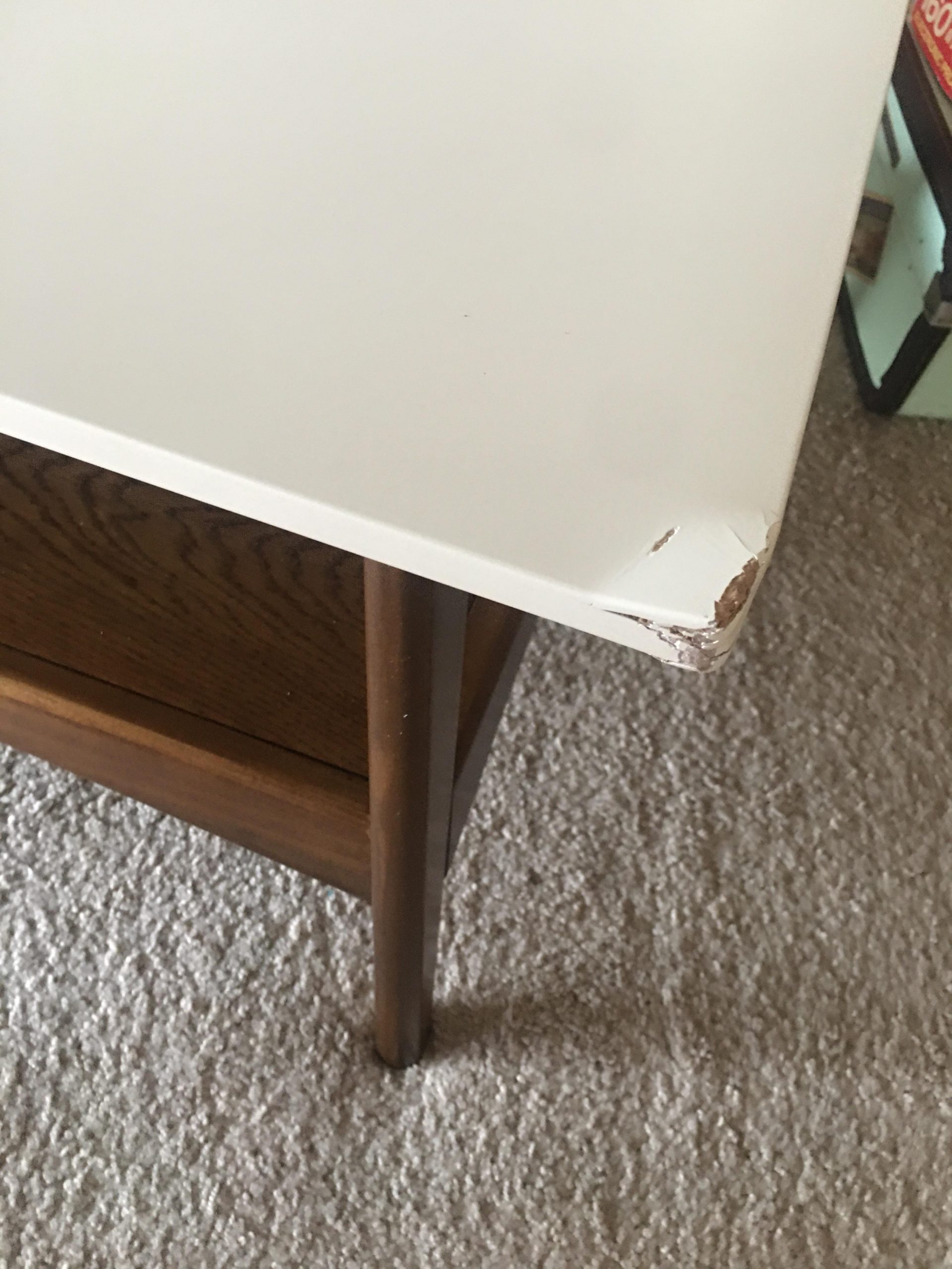 How to fix this busted up corner on my coffee table?