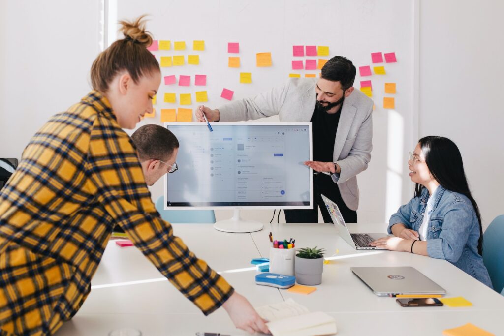 Sales Techniques and Strategies - man standing behind flat screen computer monitor