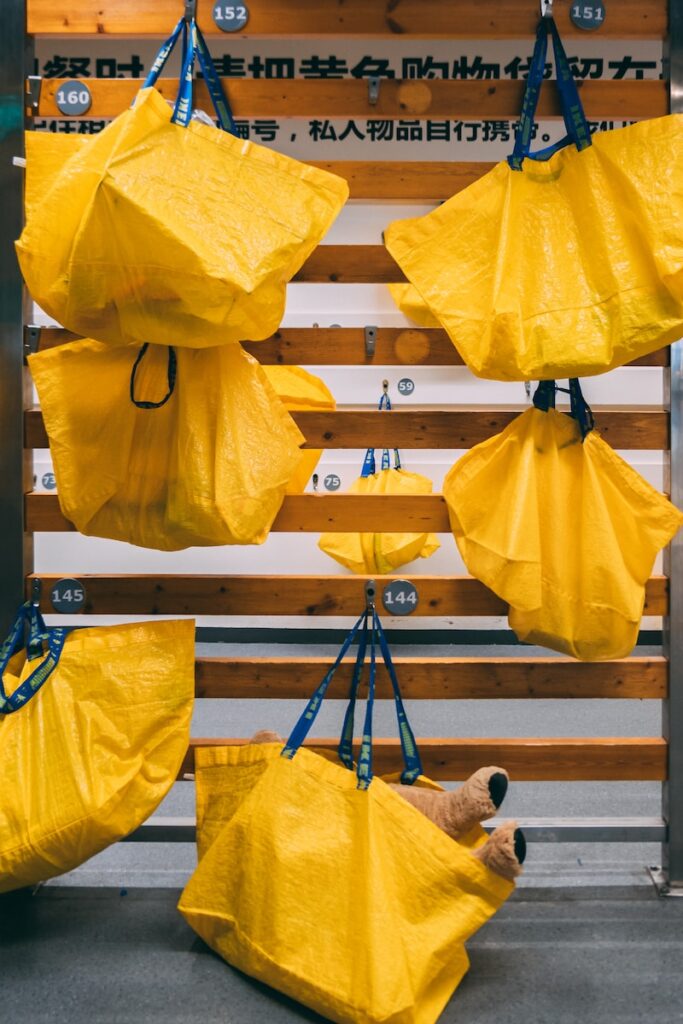 yellow paper lantern hanging on black metal bar gift boxes vs bags