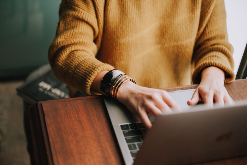 person using laptop computer digital marketing social media manager
