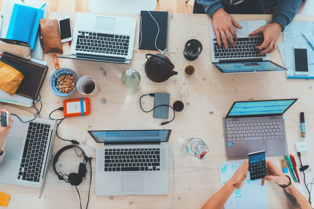 people sitting down near table with assorted laptop computers Secrets to Entrepreneurial Success