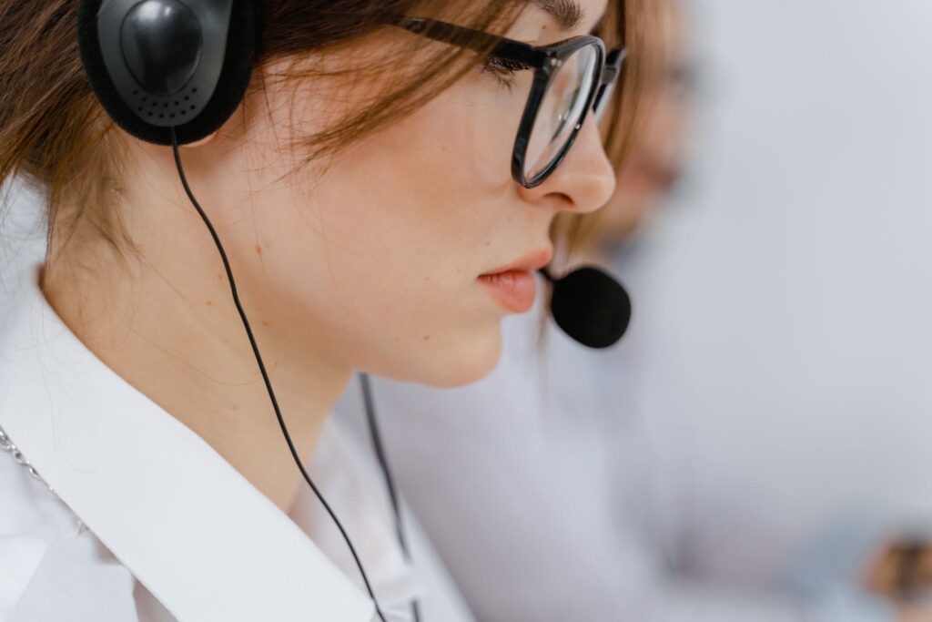 Woman Wearing Eyeglasses with Black Headset and Mouthpiece - Get Appointments