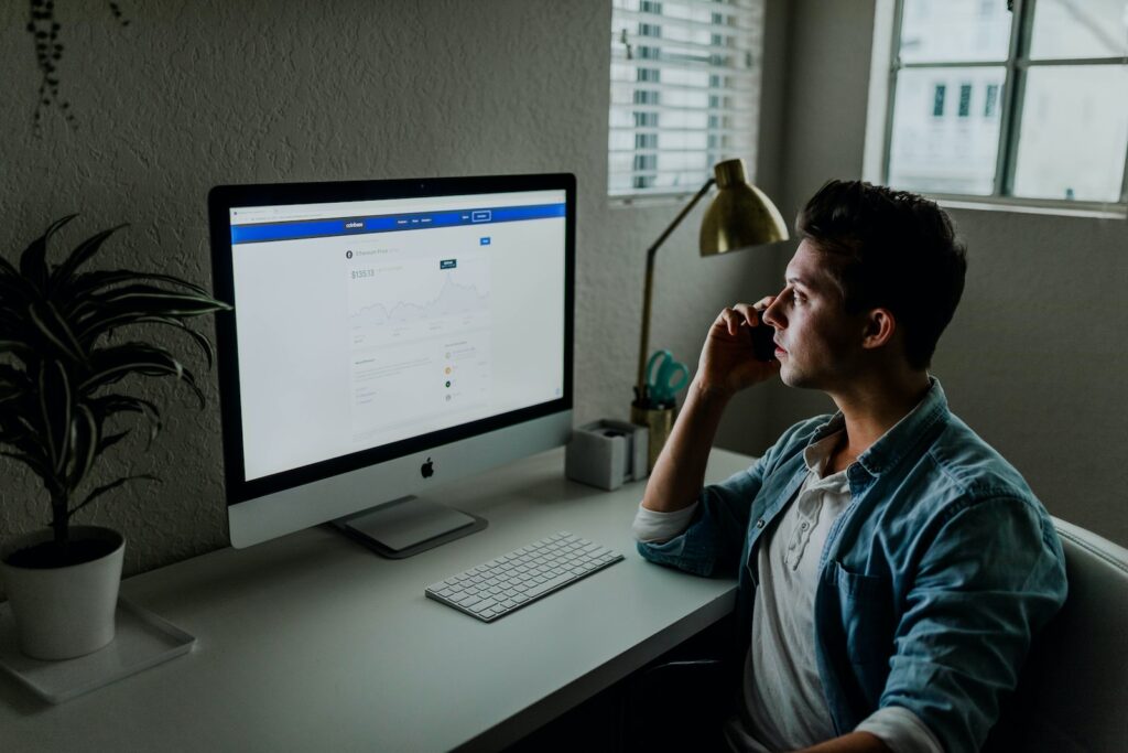 man in blue denim jacket facing turned on monitor Small business finances