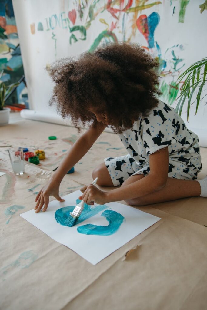 A Girl Painting on the Floor - children's drawing classes