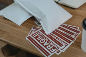 White and Red Paper on Brown Wooden Table
