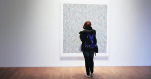 a person looking at a painting