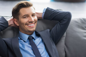 smiling young businessman with hands head